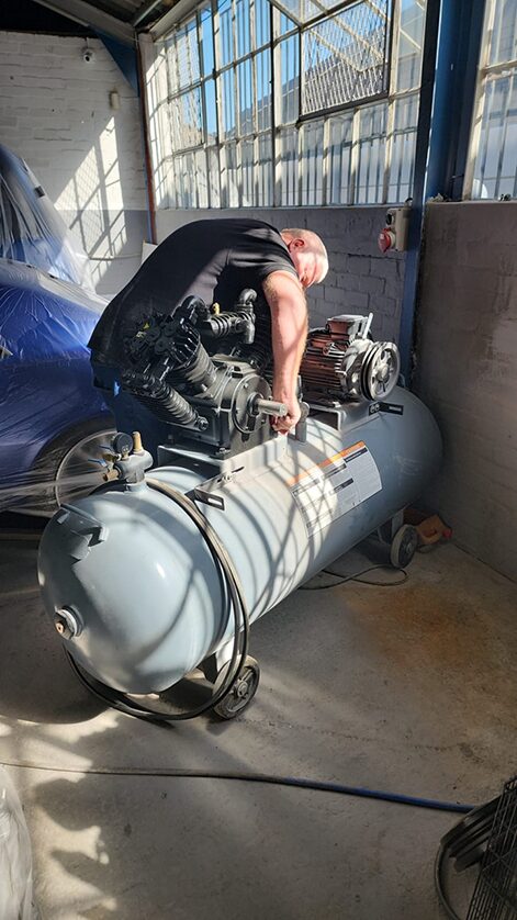 Chris performing maintenance on a compressor